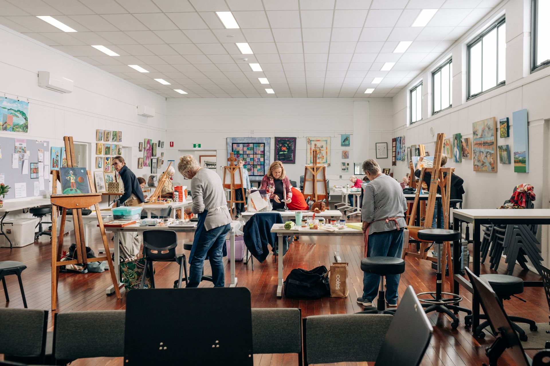 Picture: Members of The Port Lincoon Art group painting in WorkEyrea's primary workshop space