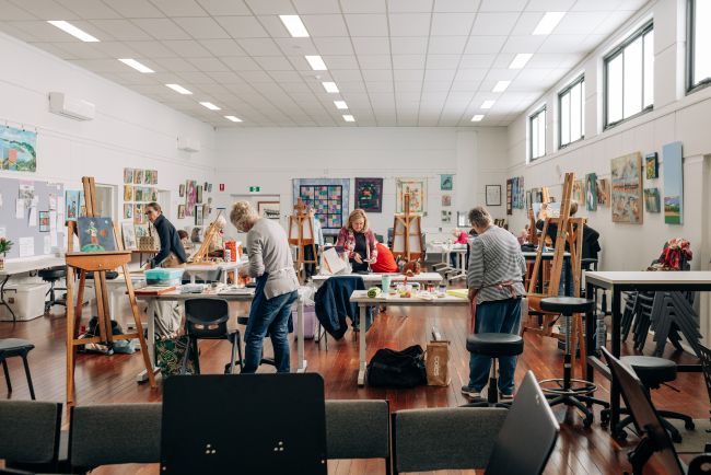Picture: Members of The Port Lincoon Art group painting in WorkEyrea's primary workshop space